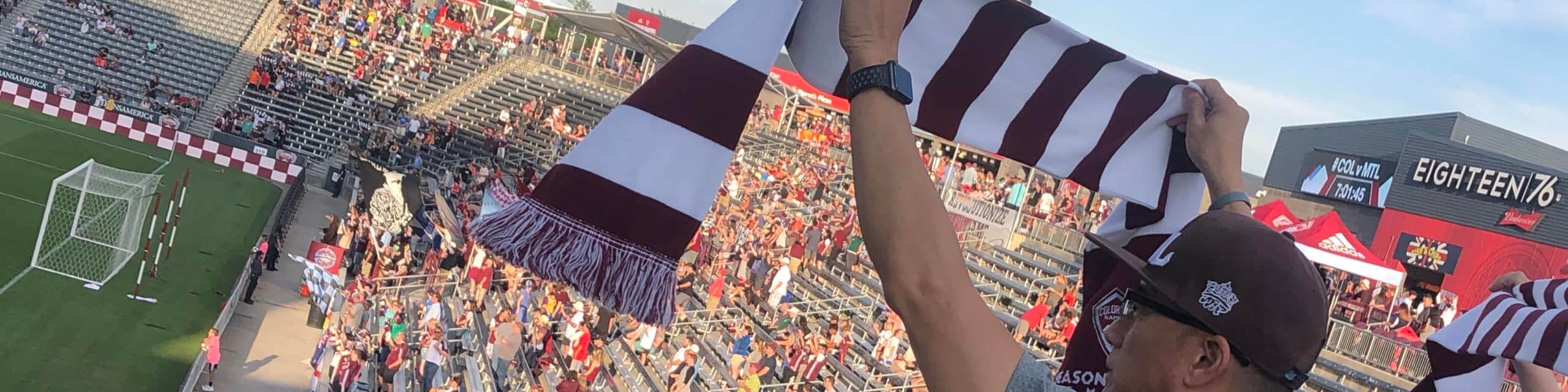fan holding scarf up at game