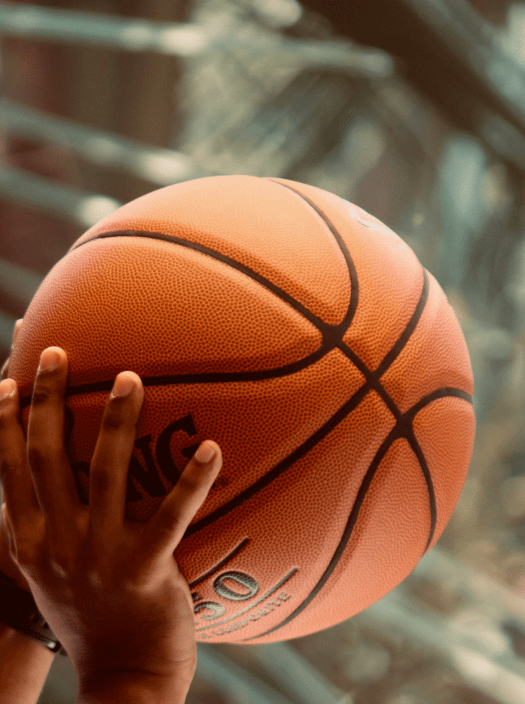 Hands holding basketball
