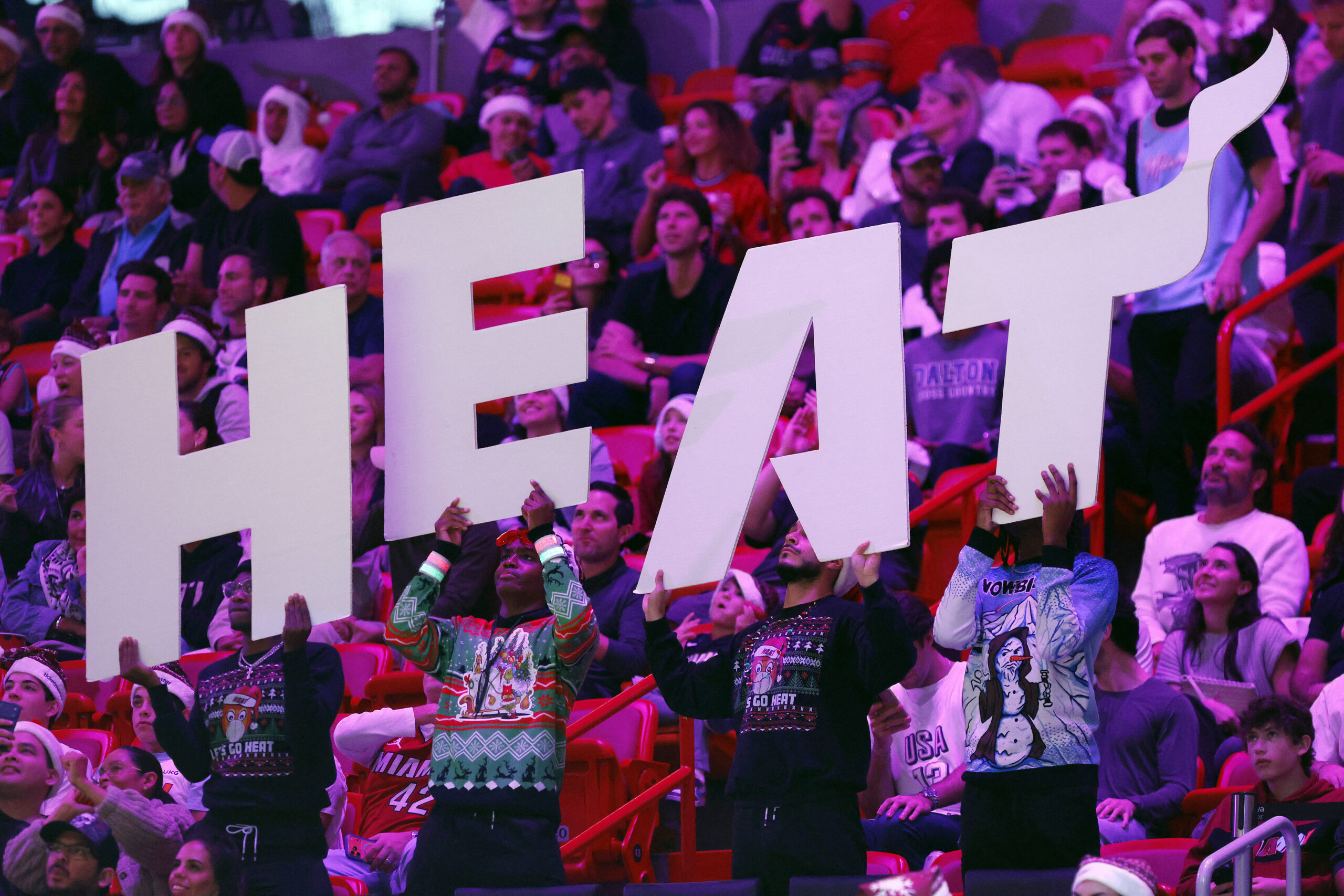 Image of Miami HEAT crowd holding up a big HEAT sign.